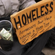 A person in economic difficulty holds a homemade sign asking for money along a New York City street on Dec. 4, 2013.
Spencer Platt/Getty Images